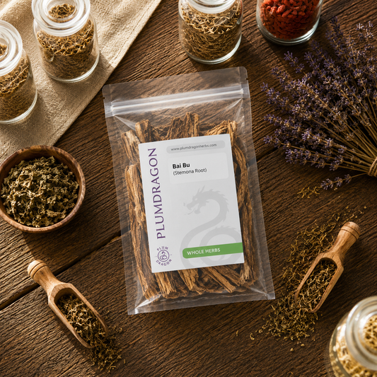 Packaged Bai Bu (Stemona Root) with a PLUM DRAGON label on a wooden surface with other herbs.