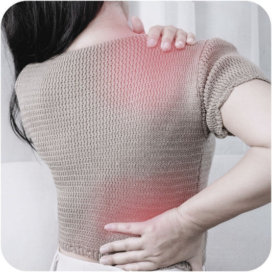 Woman stretching and in obvious pain from soft tissue injury where redness is shown on sweater