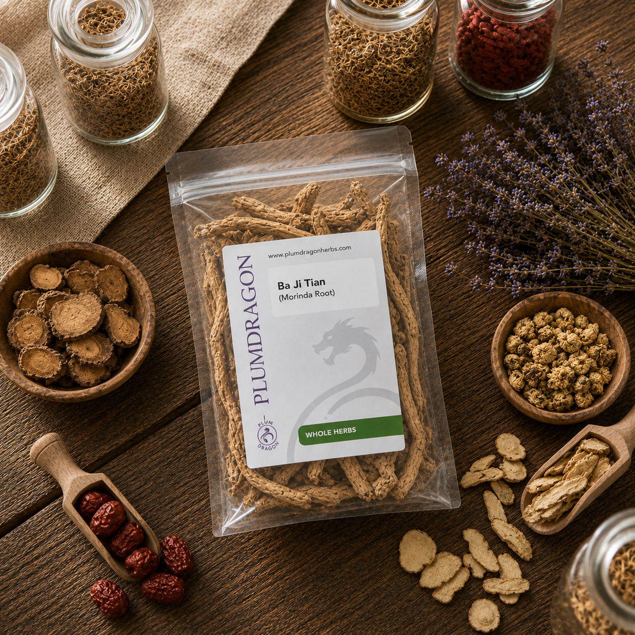 Packaged Ba Ji Tian (Morinda Root) with a Plum Dragon label on a wooden surface with various dried herbs.