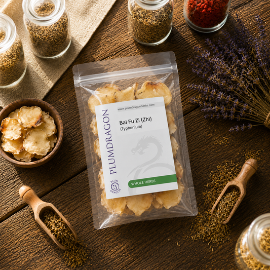 Packaged Bai Fi Zi with a Plum Dragon label on a wooden surface with herbs and spices.