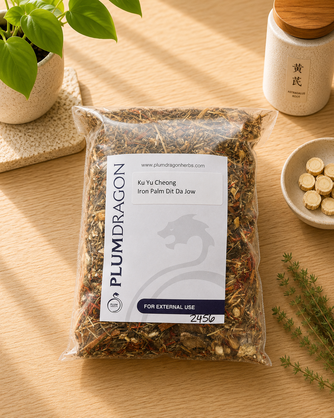 Ku Yu Cheong Iron Palm Dit Da Jow Herb Kit in Plum Dragon packaging on apothecary counter